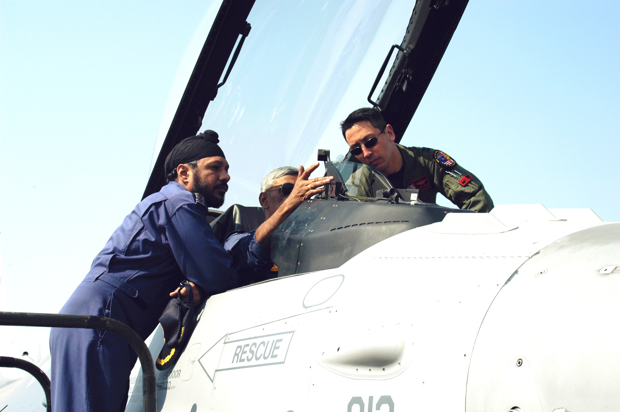 KALAIKUNDA AIR STATION, India (AFPN) -- Capt. Kevin Jones gives a cockpit tour to Indian Air Force airmen during Cope India 2006. Currently, the U.S aircraft have flown 113 sorties with the Indian air force. Captain Jones is an F-16 Fighting Falcon pilot from the 13th Fighter Squadron, Misawa Air Base, Japan. (U.S. Air Force photo by Tech Sgt. Martin Jackson)
