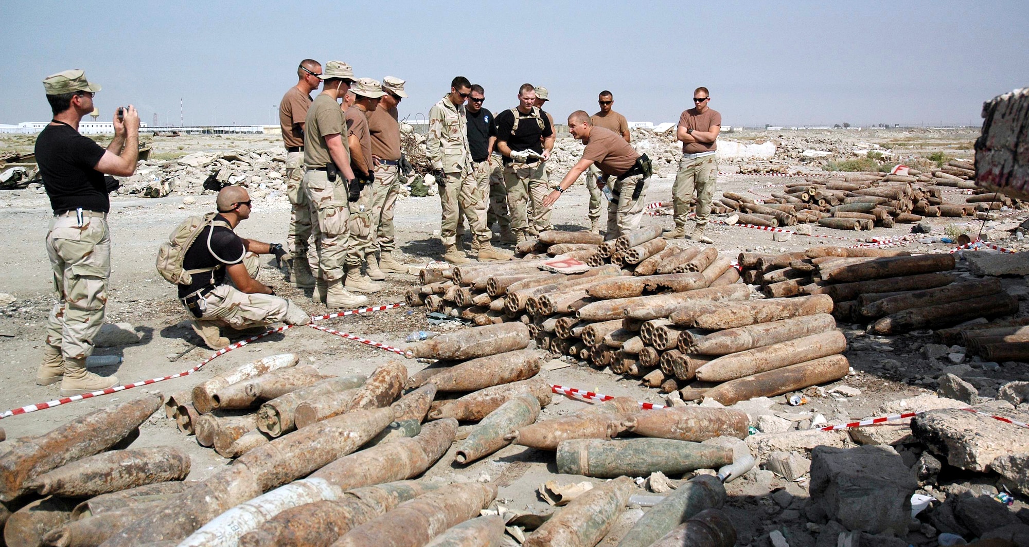 IRAQ (AFPN) -- Staff Sgt. Ron White gives direction to the volunteers who will help palletize ordnance for transportation to the explosive ordnance disposal site at Ali Base, Iraq. Sergeant White is assigned to the 407th Expeditionary Civil Engineer Squadron. (U.S. Air Force photo) 