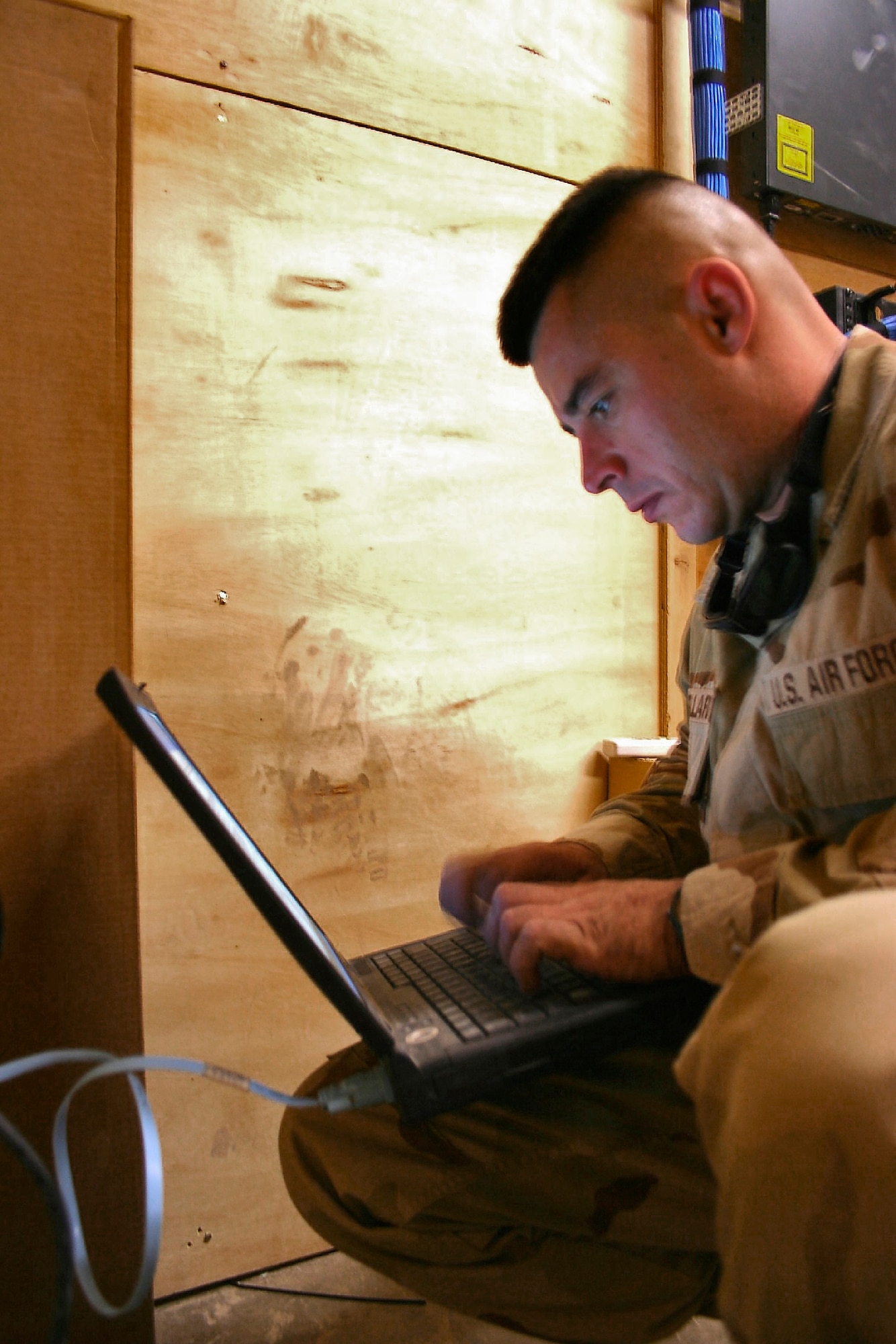 KANDAHAR AIR FIELD, Afghanistan (AFPN) -- Staff Sgt. Jeremy Bellard programs an Internet switch to prepare for the relocation of personnel from both the Kandahar Air Mobility Command passenger terminal and air terminal operations center. As U.S. forces prepare to return control of the airport terminal and tower to Afghan control, combat communicators have installed more than a mile of copper and fiber cabling. Sergeant Bellard, from Church Point, La., is deployed from the Hammond Air National Guard Station in Hammond, La. (U.S. Air Force photo by Staff Sgt. Marcus McDonald) 