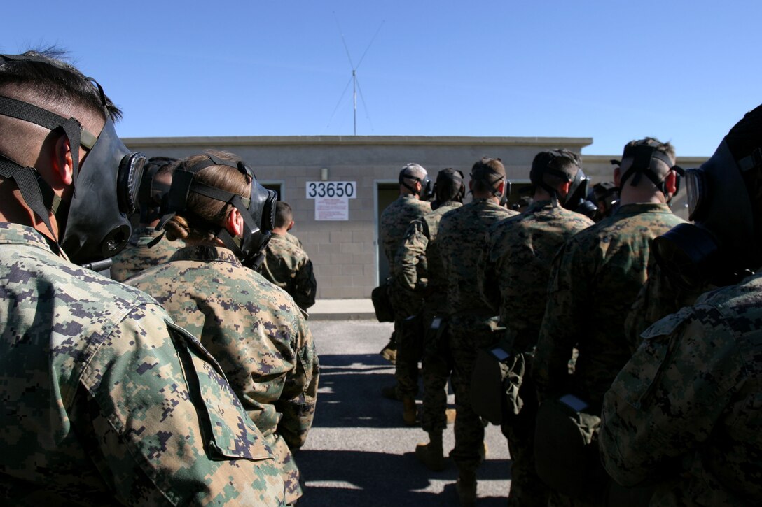 Marines with the 15th Marine Expeditionary Unit wait in line during a mask confidence exercise at the 33 Area gas chamber here. The 15th MEU participated in the exercise to ensure that the individual Marines and Sailors in the unit are confident in their field protective mask while operating in a contaminated environment.