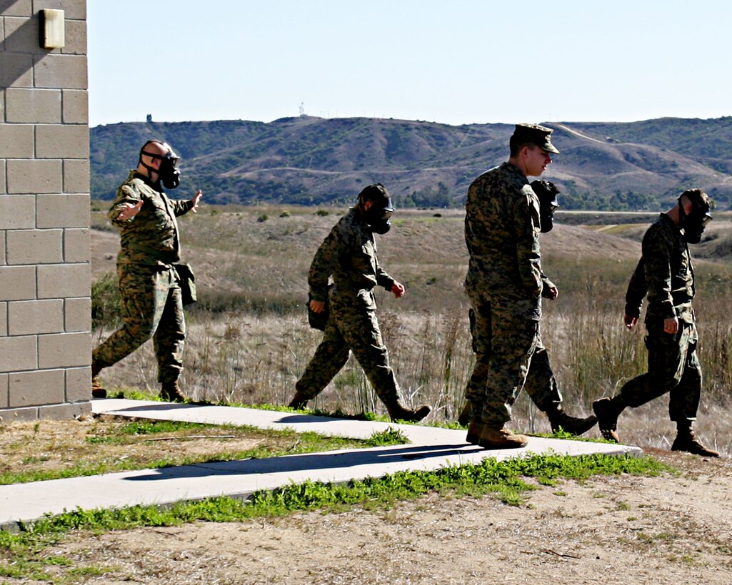 Marines with the 15th Marine Expeditionary Unit exit the 33 Area gas chamber after a mask confidence exercise here. The 15th MEU participated in the exercise to ensure that the individual Marines and Sailors in the unit are confident in their field protective mask while operating in a contaminated environment.