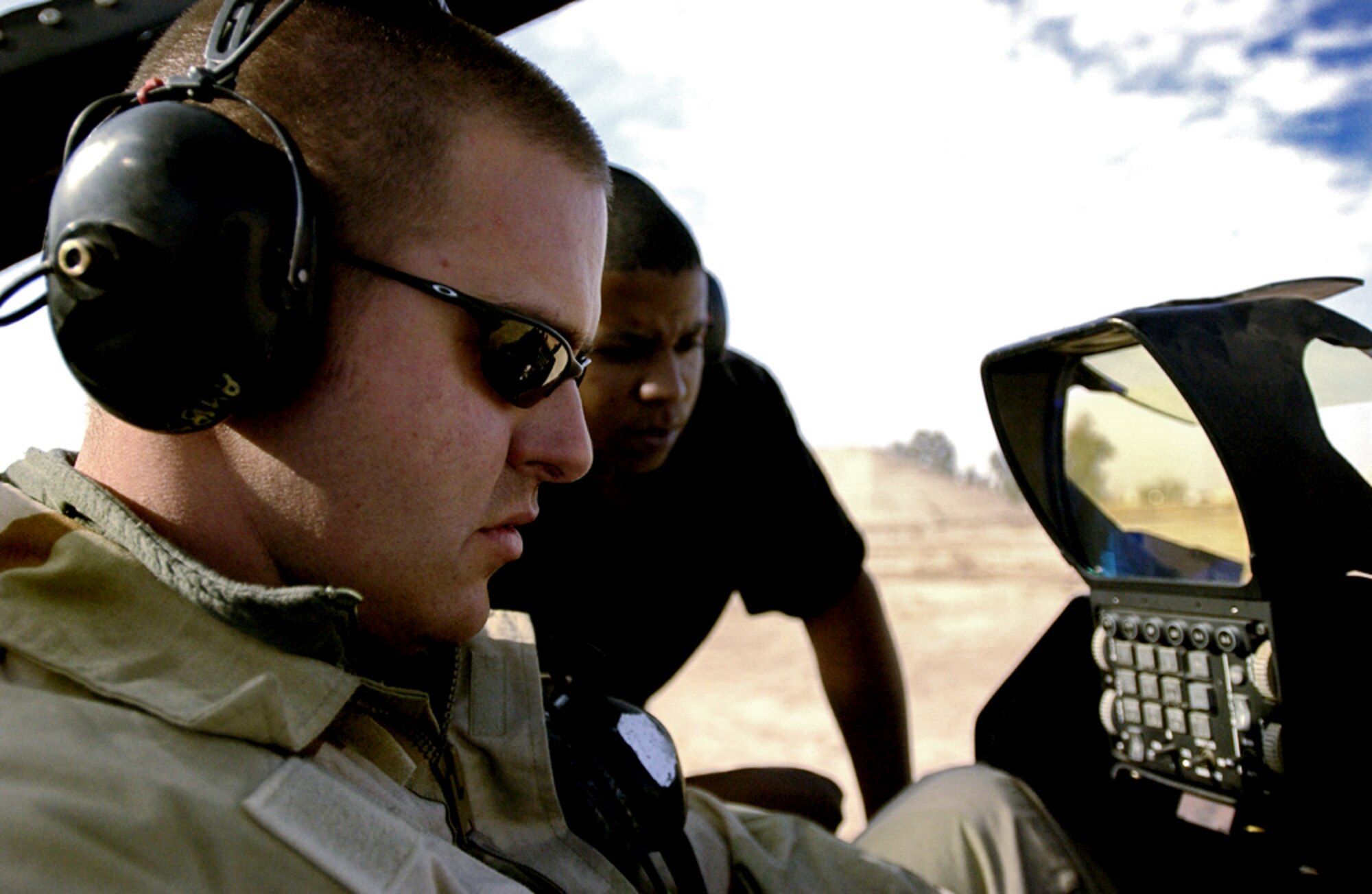 BALAD AIR BASE, Iraq (AFPN) -- Senior Airman Benjamin Buehler (left) and Airman 1st Class Jason Mckee, both from the 332nd Expeditionary Aircraft Maintenance Squadron, troubleshoot the fuel system electronics on an F-16 fighter. (U.S. Army photo by Staff Sgt. Timothy Lawn)                               