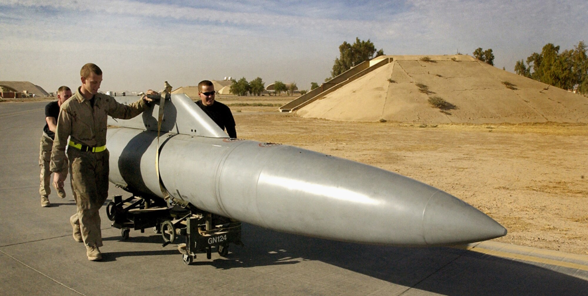 BALAD AIR BASE, Iraq --  (left to right) Staff Sgt. Duke Wilhelm, Airman 1st Class Andrew Servais and Staff Sgt. Rudy Stevens roll a fuel tank to an F-16 Fighting Falcon ready for a mission. The Airmen are with the 332nd Expeditionary Aircraft Maintenance Squadron. (U.S. Army photo by Staff Sgt. Timothy Lawn)                              