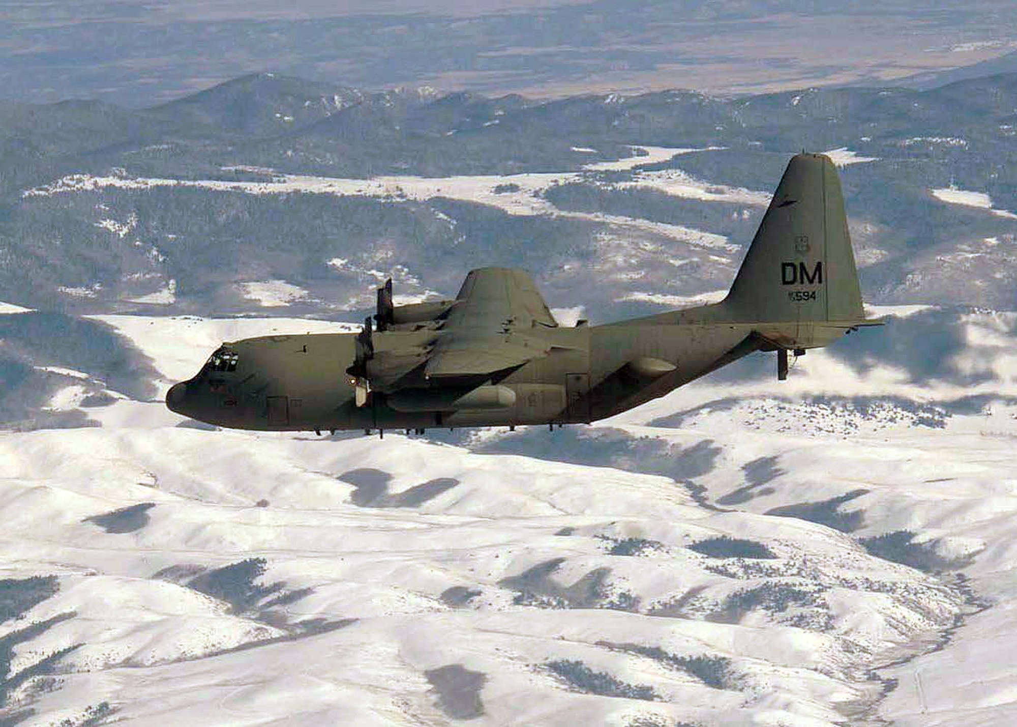 OVER COLORADO (AFPN) -- An EC-130H Compass Call aircraft flies over snow-covers hills during a training mission. The aircraft is from the 55th Electronic Combat Group at Davis-Monthan Air Force Base, Ariz. (U.S. Air Force photo by Airman 1st Class Christina D. Ponte) 