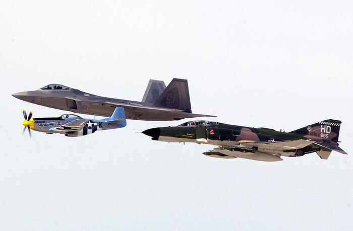 NELLIS AIR FORCE, Nev. (AFPN) -- An F/A-22 Raptor, a vintage F-4 Phantom II and a P-51 Mustang fly a heritage fly-over during the Aviation Nation 2005 air show. This year's event, held Nov. 12 and 13, was dedicated to Vietnam War veterans with a special welcome home tribute. It drew more than 150,000 spectators. (U.S. Air Force photo by Tech. Sgt. Demetrius Lester)