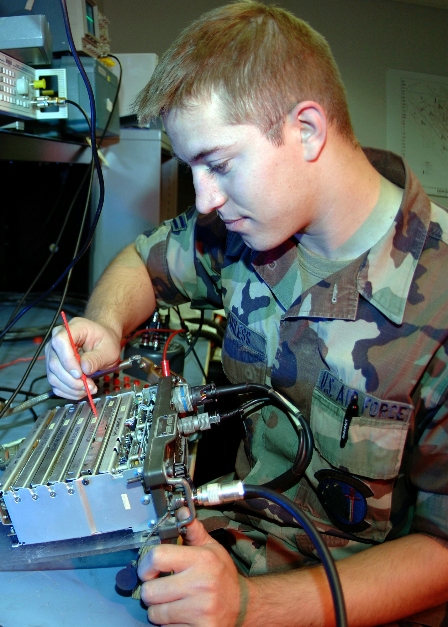 DAVIS-MONTHAN AIR FORCE BASE, Ariz. (AFPN) -- Airman 1st Class Heath Curless aligns a modular card on a receiver-transmitter unit. Airman Curless is with the 355th Communications Squadron. (U.S. Air Force photo by Airman 1st Class Christina D. Ponte) 