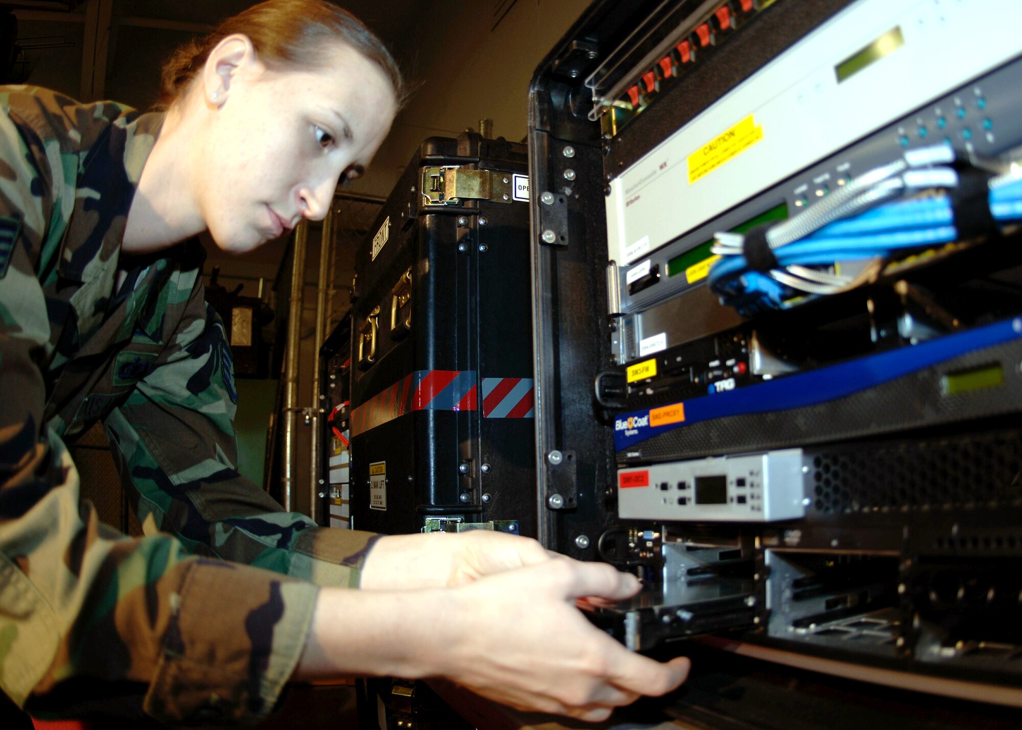 DAVIS-MONTHAN AIR FORCE BASE, Ariz. (AFPN) -- Staff Sgt. Alicia Coman installs one of six hard drives for the theater deployable communications NCC-D heavy package exchange server. Sergeant Coman is with the 355th Communications Squadron. (U.S. Air Force photo by Airman 1st Class Christina Ponte) 