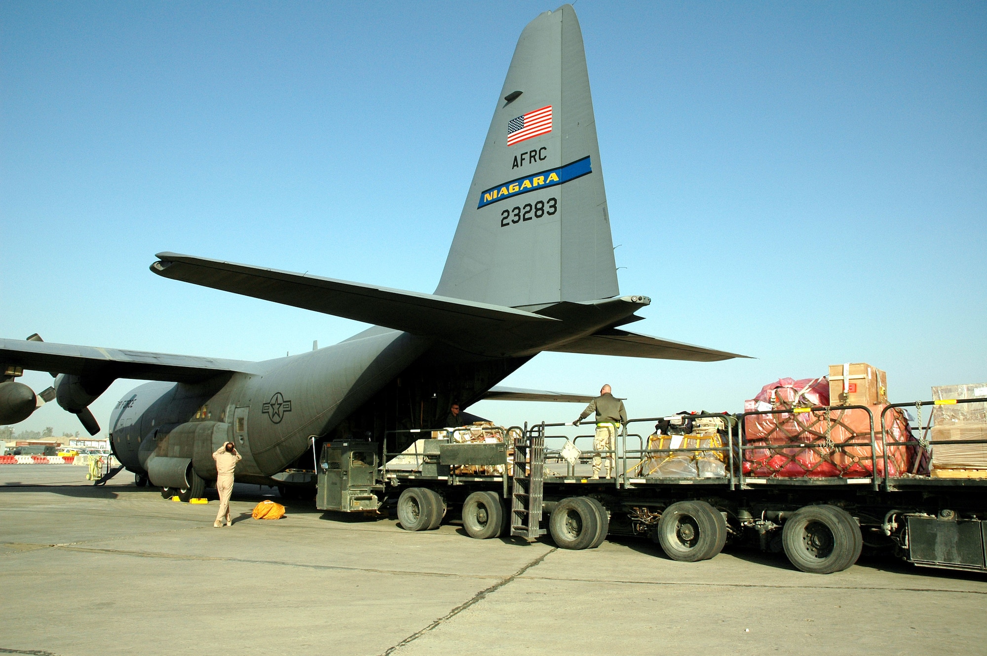 BAGHDAD, Iraq (AFPN) -- Airmen unload cargo in at the airport here brought in on C-130 Hercules mission in Iraq. (U.S. Air Force photo by Master Sgt. Peter Borys)