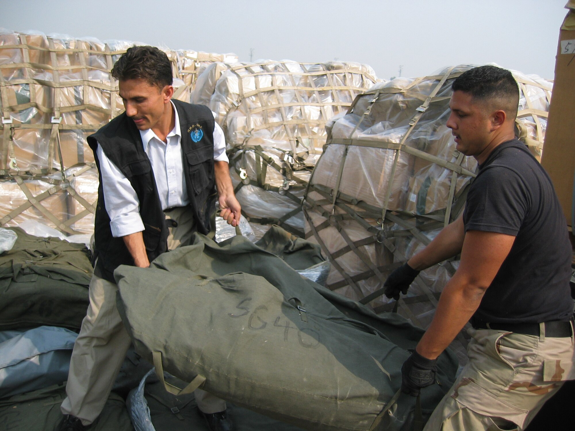 ISLAMABAD, PAKISTAN (AMCNS) – Airman 1st Class Joseph Solis, an air transportation specialist with the 818th Contingency Response Group/24th Air Expeditionary Group, helps a United Nations worker load tents. (Photo by 1st Lt. Erick Saks)