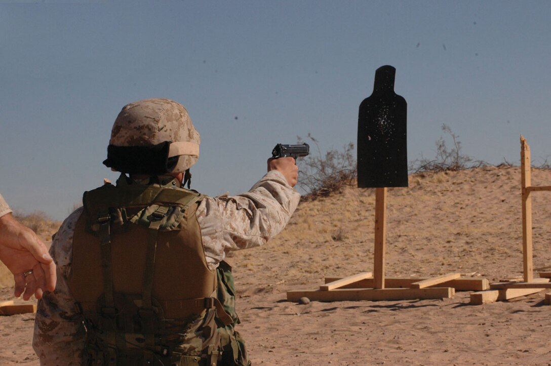 Master Sgt. Shawn Stevens, Marine Air Control Squadron 1 radar technician and native of Sequin, Wash., fires at a target with an M-9 pistol during the enhanced markmanship program range on the Barry M. Goldwater Range located southeast of the air station Nov. 17. Drills included firing with one hand in case the other hand was incapacitated.