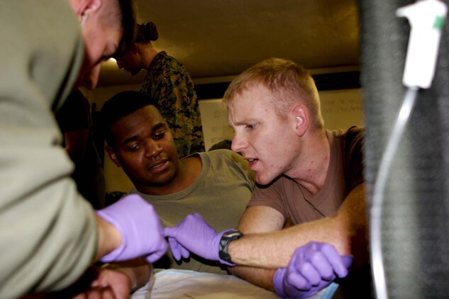 Sergeant Lance May, scout sniper, 1st Battalion, 7th Marine Regiment, receives the Bronze Star medal with combat distinguishing device from Lt. Col. Nicholas Marano, 1/7 battalion commander. May earned the medal for valorous actions as a team leader of the 1/7 Scout Sniper Platoon while serving in Operation Iraqi Freedom II.