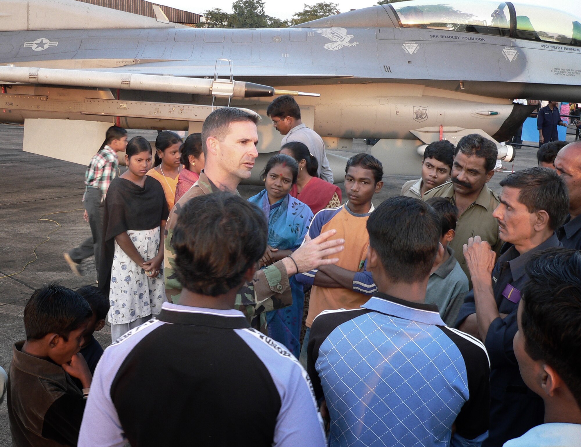 KALAIKUNDA AIR STATION, India (AFPN) -- Master Sgt. Dave Miller talks with local people who gathered to see displays of U.S. and Indian Air Force aircraft. Sergeant Miller is one of about 250 U.S. Airmen participating in the Cope India exercise. He is an aircraft section chief from Misawa Air Base, Japan. (U.S. Air Force photo by Capt. John Redfield)