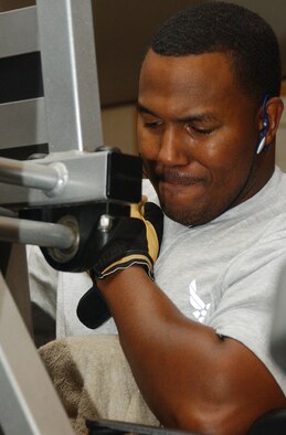 ALI BASE, Iraq (AFPN) -- Staff Sgt. Edward Weathersby works out his shoulder muscles. Sergeant Weathersby added two hours of exercise to his regular daily routine to stay fit while deployed and to make his time go faster. He is a metals technician craftsman with the 777th Expeditionary Airlift Squadron. (U.S. Air Force photo by Tech. Sgt. Paul Dean)