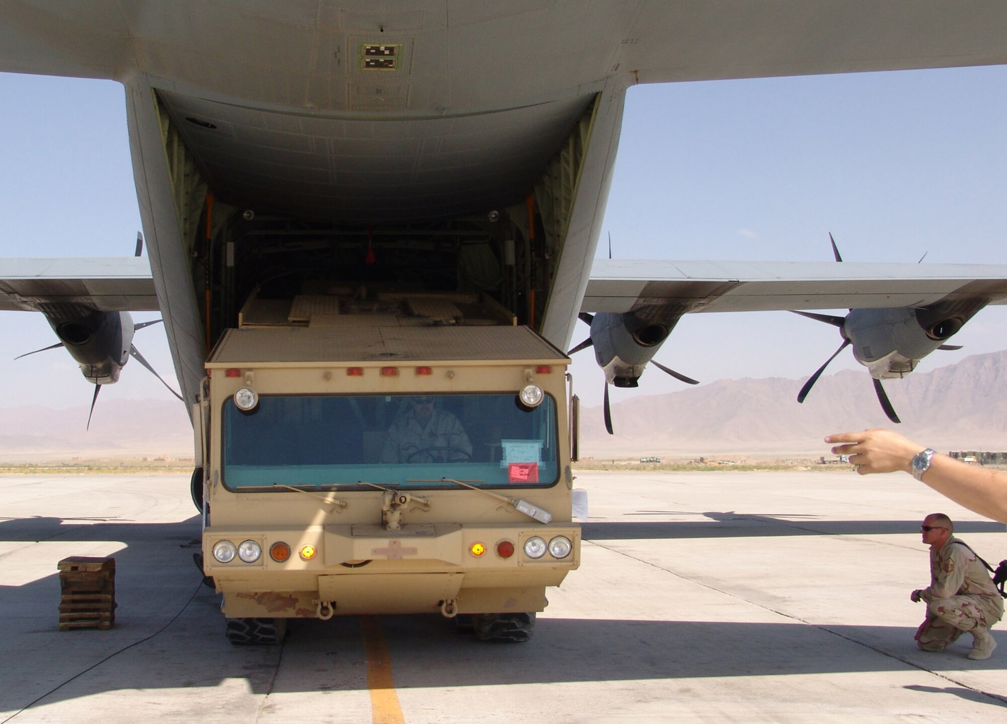 CHAGCHARAN, Afghanistan (AFPN) -- Senior Airman Victor Cardenas drives a fire truck off a C-130 Hercules at an air field in Chaghcharan in central Afghanistan. The six-man rapid-reaction fire rescue team is the only one of its kind in Afghanistan. It provides airfield rescue and fire-fighting capability to the air field. They provided fire protection for the Lithuanian Provincial Reconstruction Team. Airman Cardenas deployed from Ramstein Air Base, Germany. (U.S. Air Force photo by Master Sgt. Kevin Riehle)