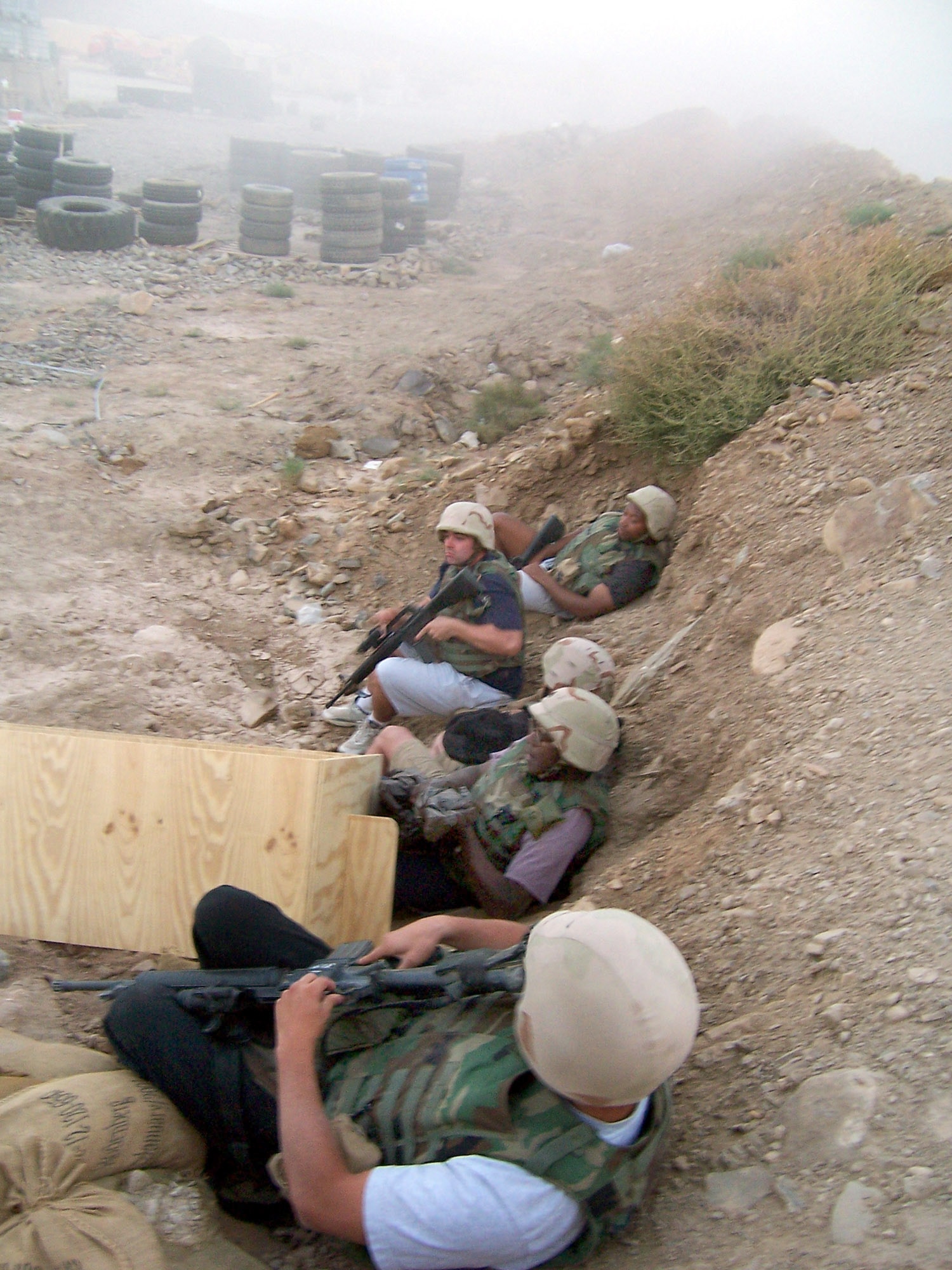 CAMP CARLSON, Afghanistan (AFPN) -- Firefighters take cover during a 107mm rocket attack at this camp in eastern Afghanistan. Five rockets struck the camp during the dusk attack, but no one was seriously injured. The six-man rapid reaction fire rescue team is the only one of its kind in Afghanistan and deployed to provide airfield fire protection for the camp. Team members are from Ramstein Air Base, Germany, and Scott Air Force Base, Ill. (U.S. Air Force photo by Master Sgt. Kevin Riehle)