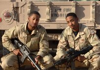 BAGHDAD INTERNATIONAL AIRPORT, Iraq -- Airmen 1st Class Travis (left) and Terence Mimms are identical twins deployed here from separate bases in Florida.  Travis, who works in supply, deployed first from Hurlburt Field, Fla., and did not know his twin was deploying to the same location.  Terence deployed from Eglin Air Force Base, Fla., where he works in security forces.  (U.S. Air Force photo by Master Sgt. Randy L. Mitchell)



