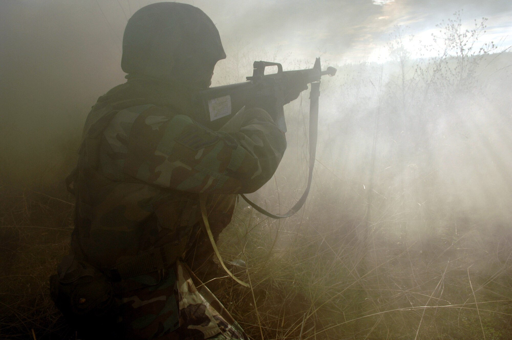 FAIRCHILD AIR FORCE BASE, Wash. (AFPN) -- An Airman takes aim into the fog during a combat skills training course. Fairchild is among the Air Mobility Command bases that have started conducting combat skills training. (U.S. Air Force photo by Airman 1st Class Clay Lancaster)