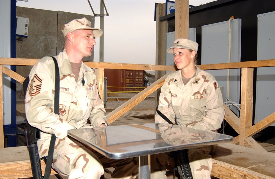 BALAD AIR BASE, Iraq (AFPN) -- Reserve Senior Master Sgt. Michael Brimmer and his niece, Army Spc. Angie Fekken, relax during some down time. Sergeant Brimmer is assigned to the 332nd Expeditionary Security Forces Squadron and Specialist Fekken is assigned to the 1436th Engineer Company. (U.S. Air Force photo by Staff Sgt. Tammie Moore) 