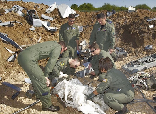 BROOKS CITY-BASE, Texas (AFPN) -- Students of the Aircraft Mishap Investigation and Prevention course at the U.S. School of Aerospace Medicine sift through the "wreckage" at a mock aircraft crash site.  The site is used in field exercises to give students a realistic idea what an actual site might be like. The course recently underwent changes, moving from a primarily lecture-based format to a more hands-on, problem-based learning approach. (Air Force photo by Tech. Sgt. Alfonso Ramirez)