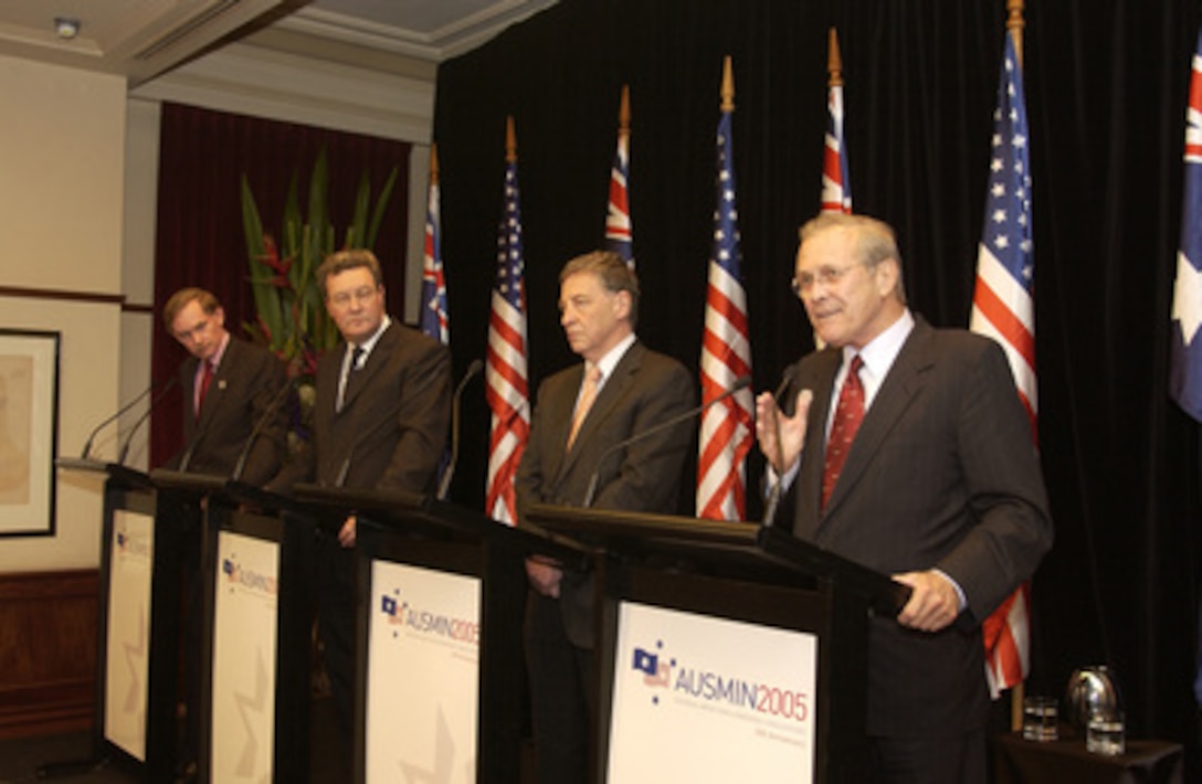 Secretary of Defense Donald H. Rumsfeld (right) answers a reporter's question during a joint press conference with Australian Minister for Defense Robert Hill (2nd from right), Australian Foreign Minister Alexander Downer (3rd from right) and U.S. Deputy Secretary of State Robert Zoellick, at the Town Hall in Adelaide, Australia, on Nov. 18, 2005. Rumsfeld and Zoellick are in Adelaide for the annual Australian-United States Ministerial Conference. 