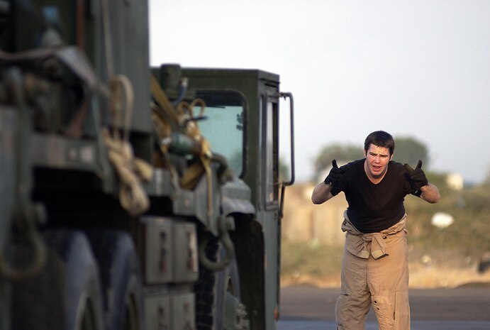 CAMP LEMONIER, Djibouti -- Loadmaster Senior Airman Jake Wyatt directs the loading of a well rig into a C-17 Globemaster III cargo plane here today. The cargo is bound for Gode, Ethiopia. The 747th Engineer Detachment will deploy there to dig four wells to supply safe drinking water. The engineers, deployed to Combined Joint Task Force-Horn of Africa, support Operation Enduring Freedom. Airman Wyatt is with the 14th Airlift Squadron at Charleston Air Force Base, S.C. (U.S. Air Force photo by Staff Sgt. Stephen Schester)