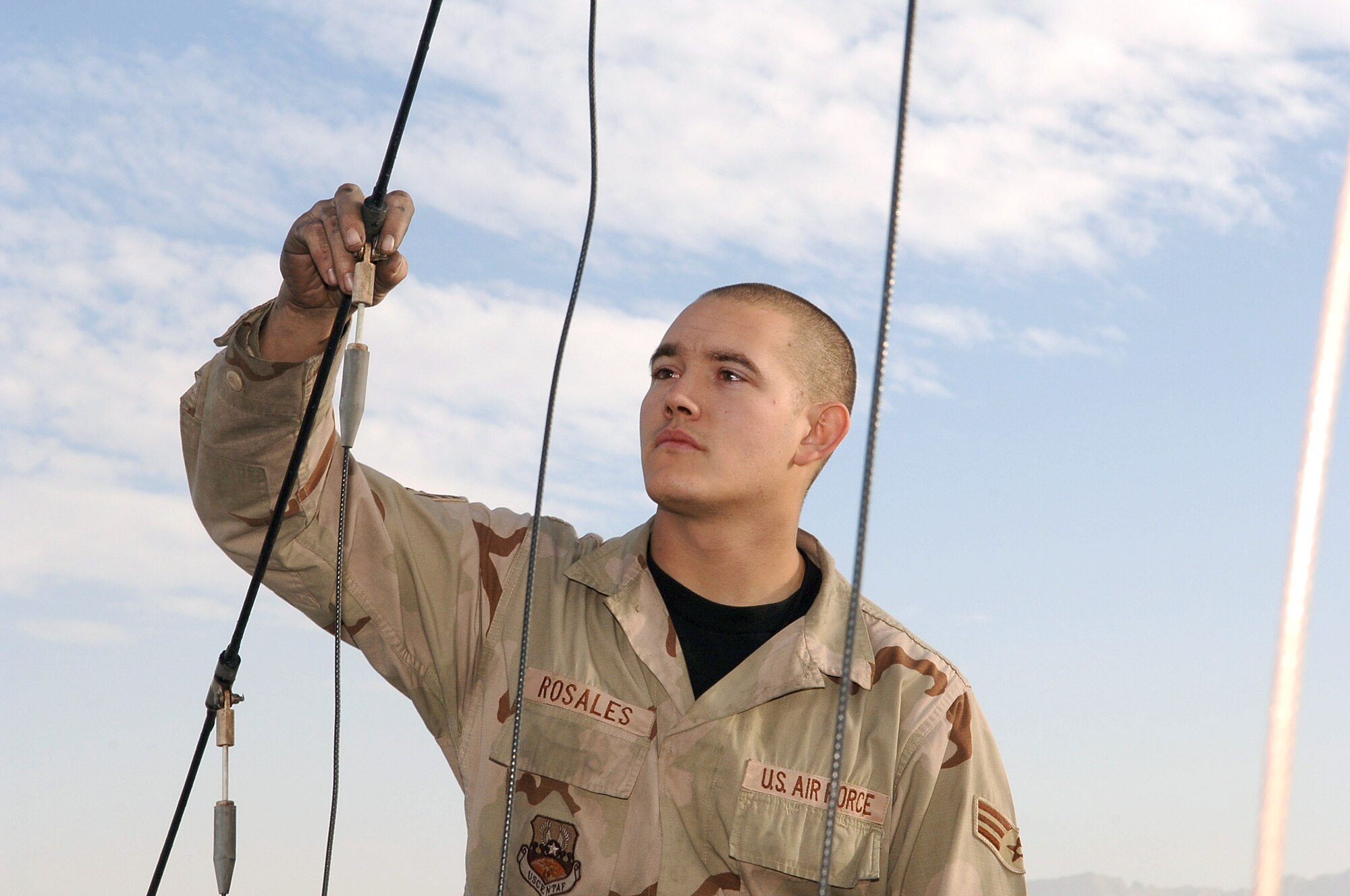 BAGRAM AIR BASE, Afghanistan (AFPN) -- Senior Airman Alexander Rosales inspects antennae elements for fraying on an EC-130H Compass Call's. Airman Rosales is with the 41st Expeditionary Electronic Combat Squadron and deployed from Davis-Monthan Air Force Base, Ariz. (U.S. Air Force photo by Capt. James H. Cunningham) 