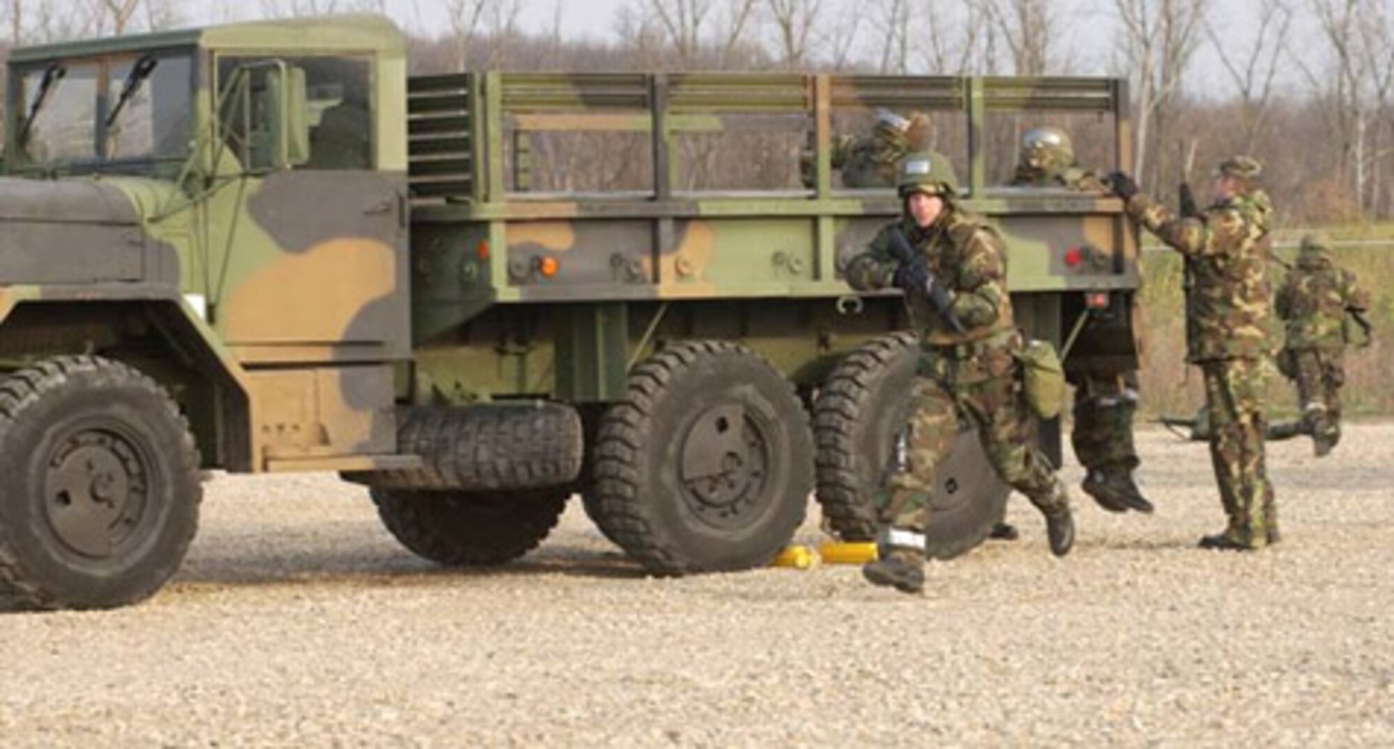 WRIGHT-PATTERSON AIR FORCE BASE, Ohio (AFMCNS) -- A simulated attack 
on a convoy has Maj. Mark Lozier, of Air Force Research Laboratory Air Vehicles
Directorate, run to a defensive position around the vehicles Nov. 17 near the 445th 
Civil Engineer Squadron's Base Engineer Emergency Force, or Prime BEEF, camp
in Area C. The purpose of the exercise was for members to learn how to defend 
themselves should a convoy encounter enemy fire. (Air Force photo by Spencer P. Lane)