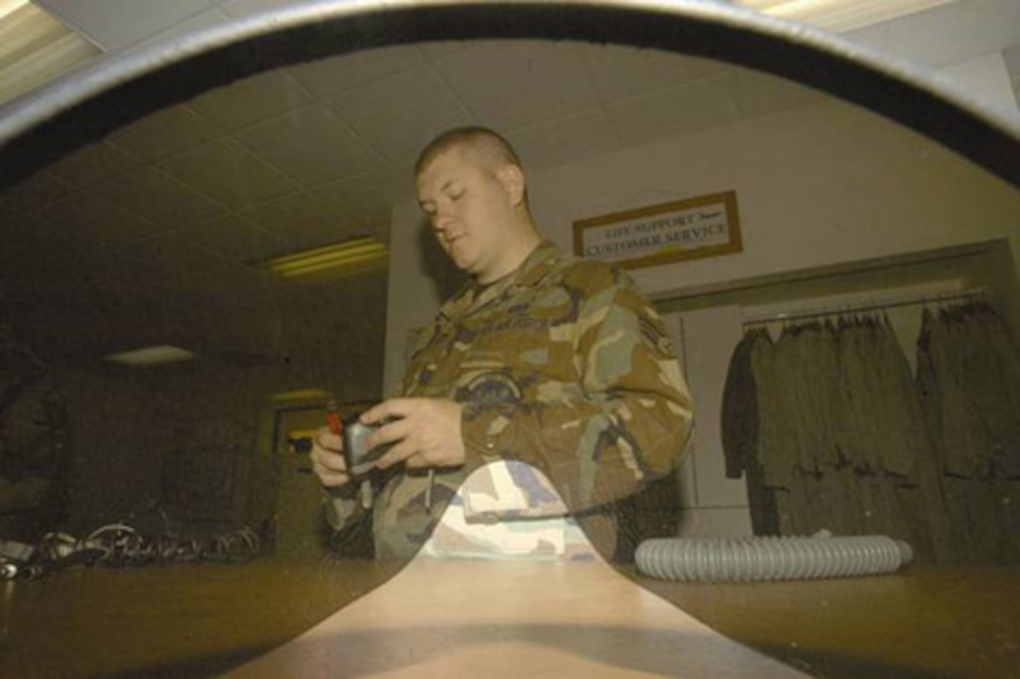 EDWARDS AIR FORCE BASE, Calif. (AFMCNS) -- Senior Airman Andrew Smith, 412th
Operations Support Squadron Life Support technician, helps reassemble a helmet 
and oxygen mask. (Air Force photo by Senior Airman Jet Fabara)