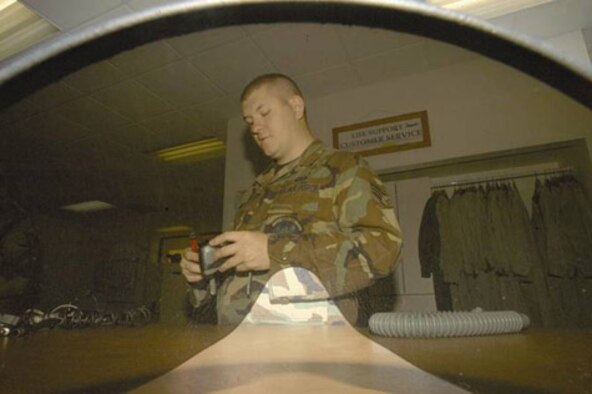 EDWARDS AIR FORCE BASE, Calif. (AFMCNS) -- Senior Airman Andrew Smith, 412th
Operations Support Squadron Life Support technician, helps reassemble a helmet 
and oxygen mask. (Air Force photo by Senior Airman Jet Fabara)