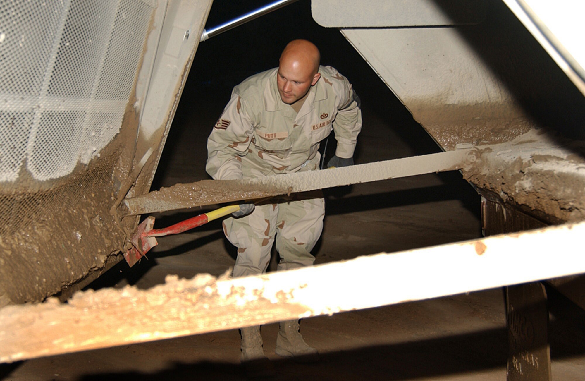 BALAD AIR BASE, Iraq (AFPN) -- Staff Sgt. Jason Putt cleans off a road sweeper before turning it over to the next shift. Sergeant Putt is with the 332nd Expeditionary Civil Engineering Squadron. (U.S. Air Force photo by Tech. Sgt. Pamela Anderson) 