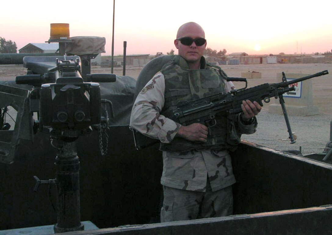 NORTHERN IRAQ -- Senior Airman Brian Leverton, stands ready with an M-249 rifle before a morning fuel run. Airman Leverton was part of a special Air Force unit that provided security to Army convoys. He was deployed from Whiteman Air Force Base, Mo. (U.S. Air Force photo)