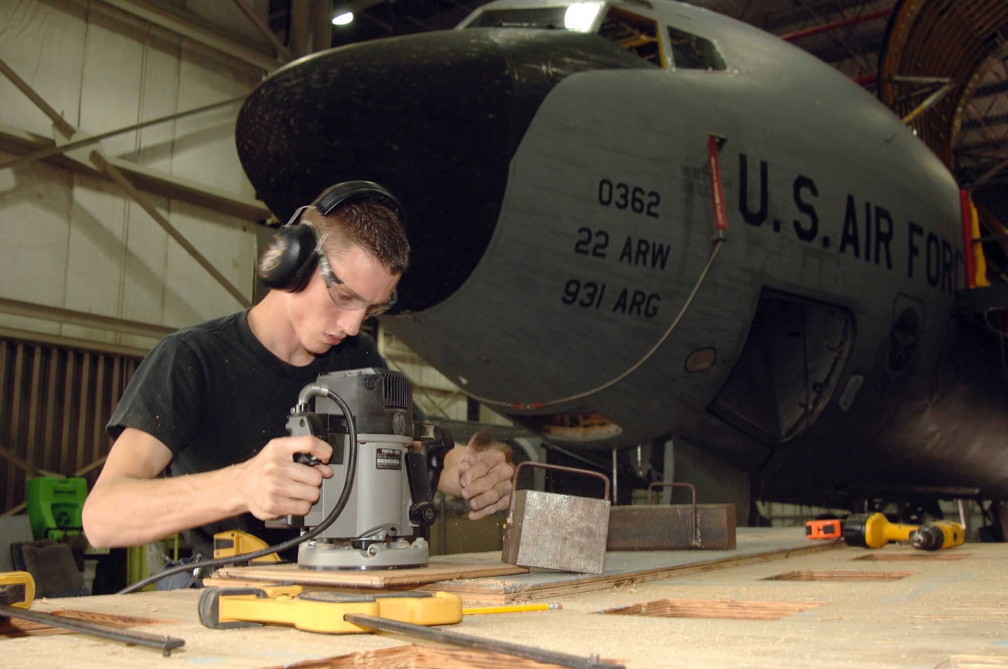 MCCONNELL AIR FORCE BASE, Kan. -- Senior Airman Kory Meda with the 22nd Maintenance Squadron routes replacements floorboards during a KC-135 refurbishing project here.  (U.S. Air Force photo by Tech. Sgt. Michael Boquette)