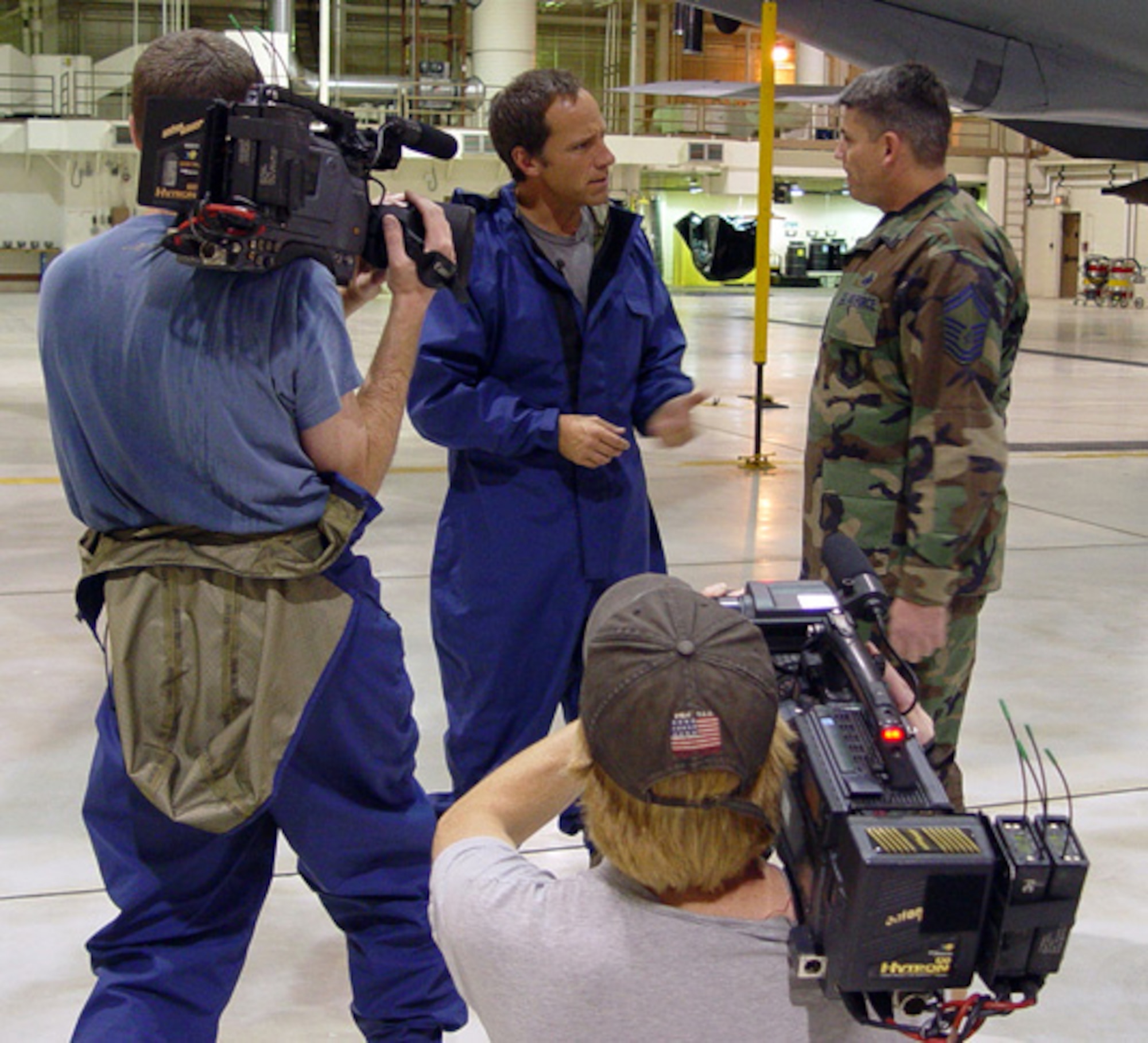 MCCONNELL AIR FORCE BASE, Kan. (AFPN) -- Mike Rowe, host and star of the Discovery Channel's "Dirty Jobs," talks with Senior Master Sgt. Kenneth Casey about fuel cell maintenance procedures. The television show visited the base Nov. 21 and 22 to tape an episode on the "dirty job" performed by fuel cell maintainers from the 22nd Maintenance Squadron. Sergeant Casey is assigned to the 22nd MXS. (U.S. Air Force photo by 1st Lt. Ashley Conner)