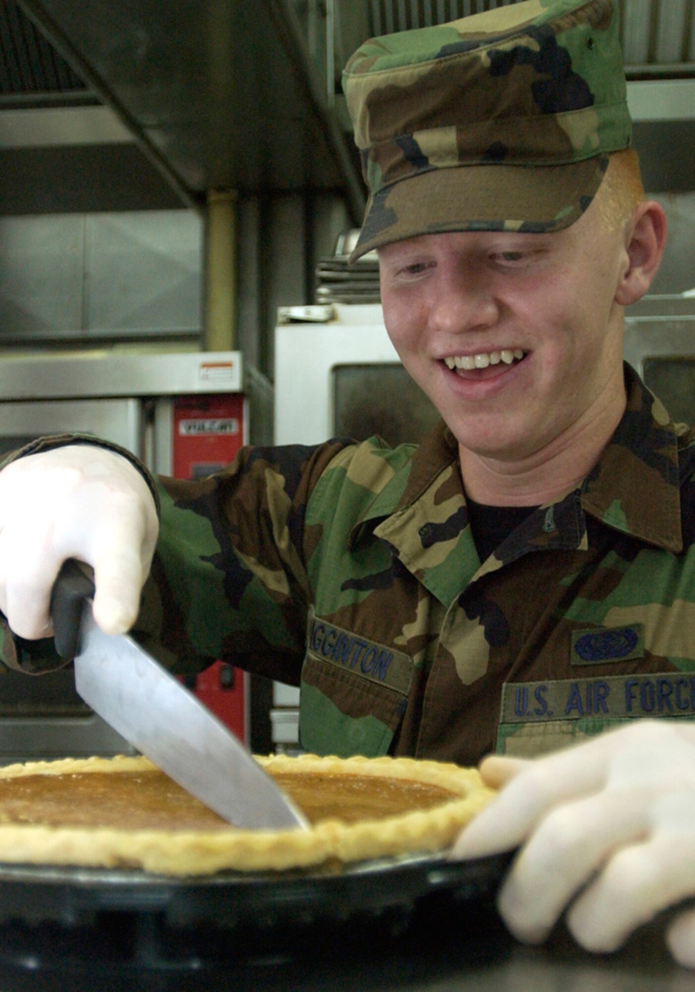 ANDERSEN AIR FORCE BASE, Guam (AFPN) -- Airman Brandon Wigginton slices a pumpkin pie for the Thanksgiving festivities here. He is assigned to the 36th Service Squadron. (U.S. Air Force photo by Airman Michael S. Dorus)