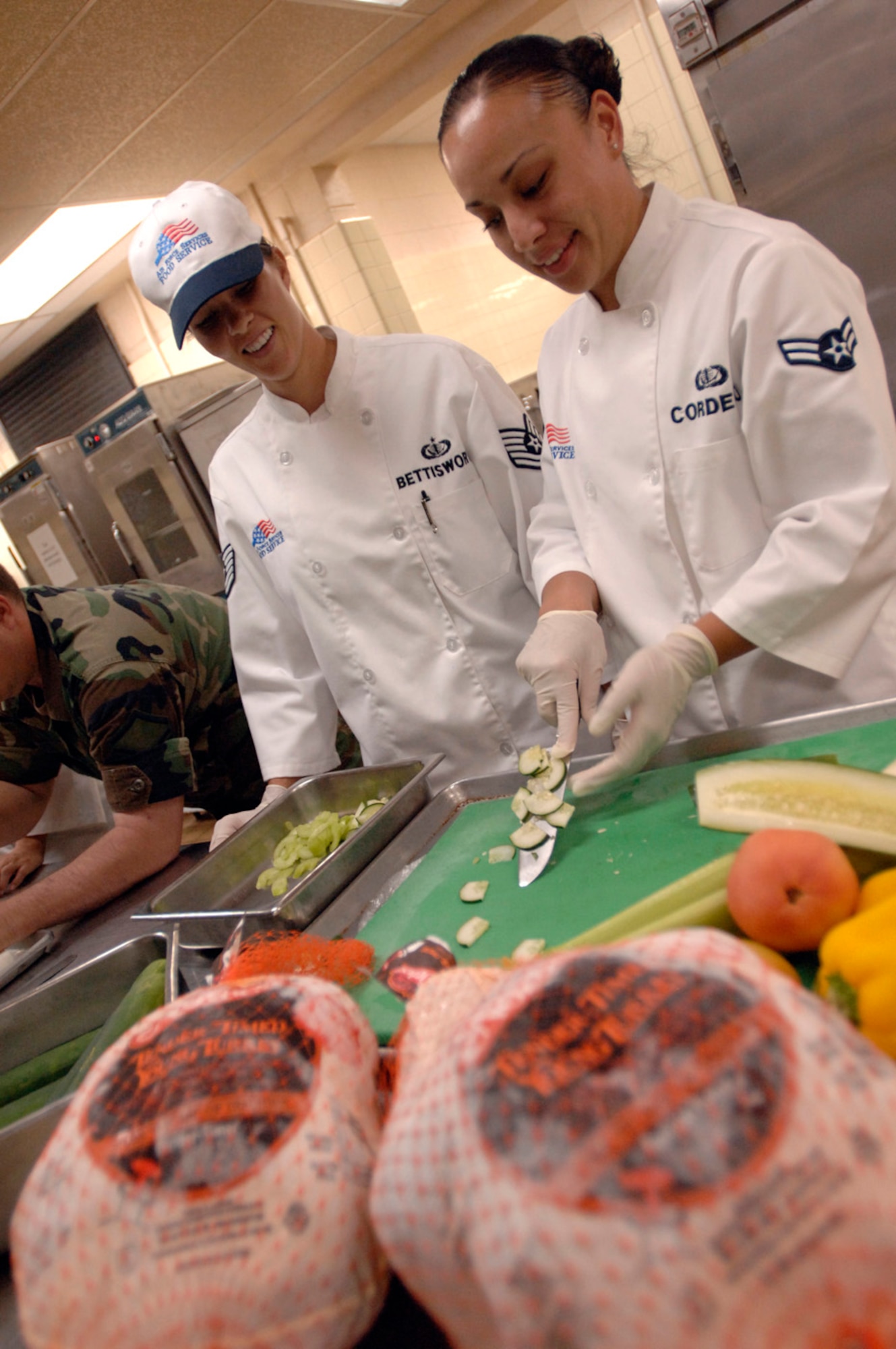 ANDERSEN AIR FORCE BASE, Guam (AFPN) -- Tech. Sgt. Tiffany Bettisworth (left) and Airman 1st Class Melissa Cordero make vegetable show pieces for the Thanksgiving festivities here. They are assigned to the 36th Services Squadron. (U.S. Air Force photo by Tech. Sgt. Cecilio Ricardo Jr.)