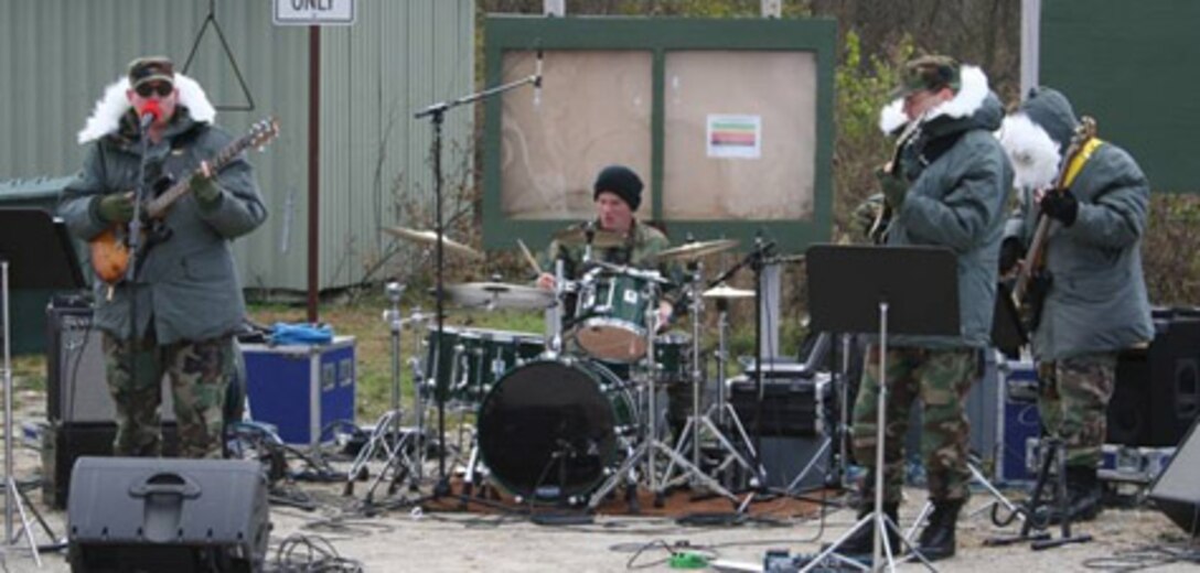 WRIGHT-PATTERSON AIR FORCE BASE, Ohio (AFMCNS) - (Left to Right) Master Sgt. Shawn Stanley, guitar and vocals, Master Sgt. Robert Green, drums; Tech. Sgt. Cameron Voorhees, guitar and Master Sgt. Vincent Marshall, electric bass entertain participants in Freezing Rivers 05-4, a quarterly readiness exercise , Nov. 17. The four NCOs, along with audio engineer Senior Airman Joshua Deal, are part of the U.S. Air Force Band of Flight's rock band, "Systems Go." (Air Force photo by 1st Lt. Ellen Harr)