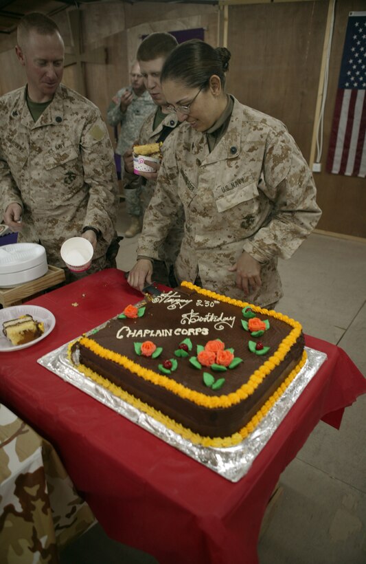 Navy Lt. Michael Wietecha cuts a cake in celebration of the Navy Chaplain Corps? 230th birthday.  The ceremony took place at Al Asad, Iraq, Nov. 28.
