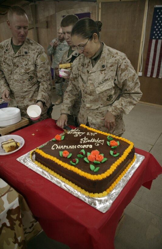 CAMP TAQADDUM, Iraq (Nov. 28, 2005) ? Petty Officer 3rd Class Rachel A. Eichenberger helps pass out cake here Nov. 28. Sailors, Marines and Soldiers came together under one roof to celebrate the 230th Navy Chaplain Corps?s birthday. Although the ceremony was minus the company of loved ones from home, everyone was in good spirits to be celebrating their proud tradition with 2nd Marine Logistics Group (Forward). Eichenberger is a religious program specialist with Mortuary Affairs, 2nd MLG (FWD).