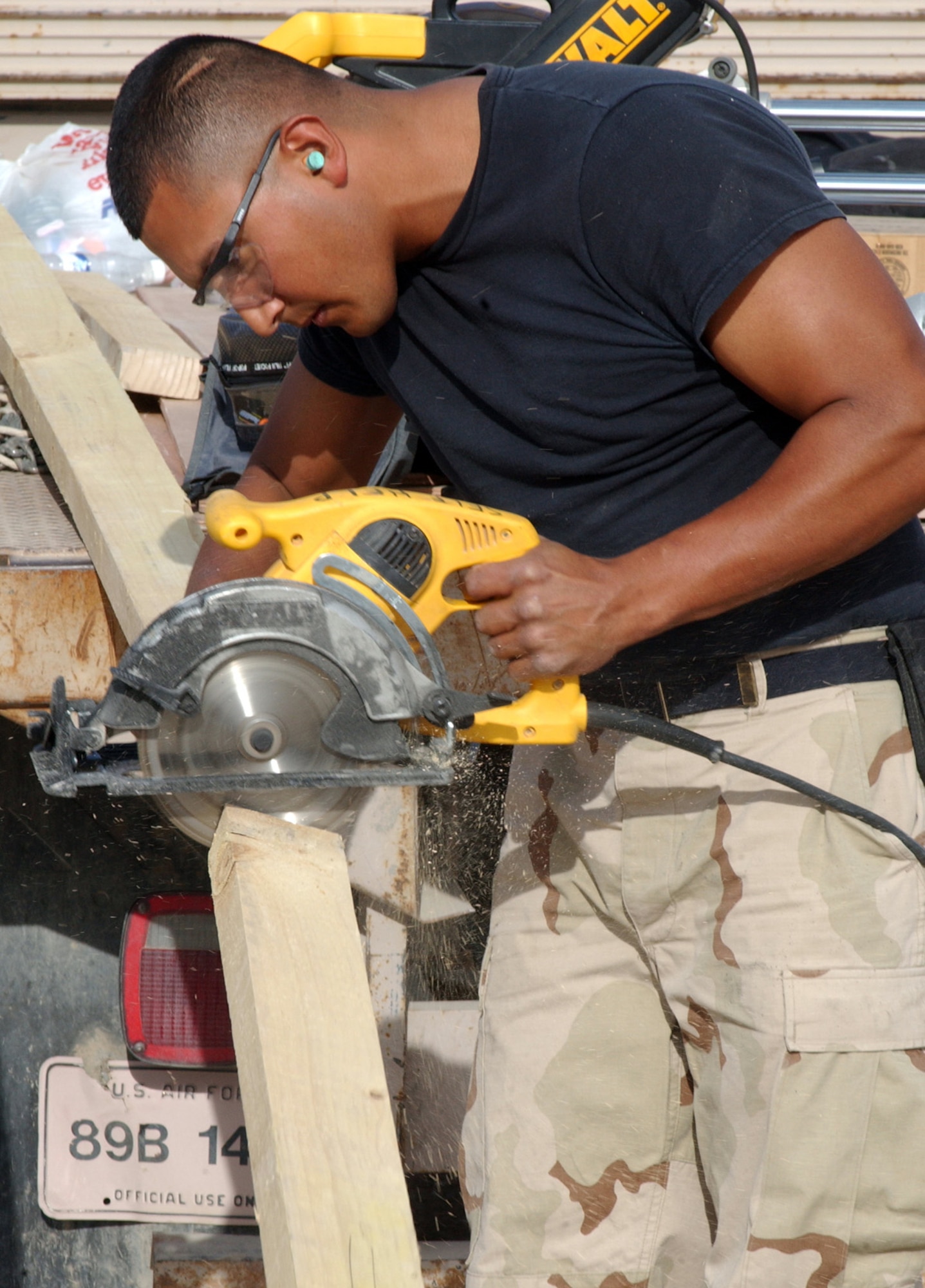 ALI BASE, Iraq (AFPN) -- The base fitness center is expanding with the addition of a separate aerobics room. The new tent is up, the breezeway between the two tents has been built and Senior Airman Omar Hernandez is building a frame for the flooring. Airman Hernandez is with the 407th Expeditionary Civil Engineer Squadron (U.S. Air Force photo by Tech. Sgt. Paul Dean)