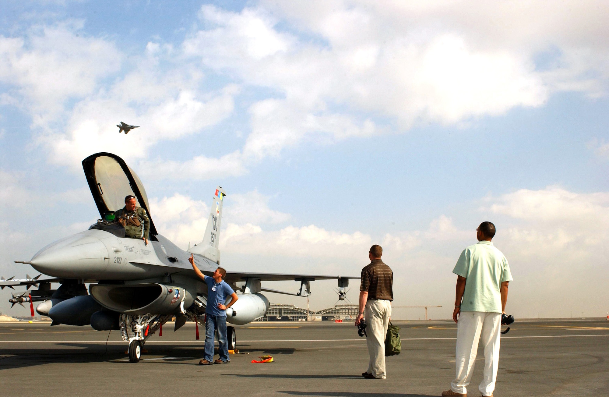 DUBAI, United Arab Emirates (AFPN) -- Capt. Michael Dietrich is greeted by Senior Airman Robert Wince, Capt. Clinton Waller and Master Sgt. Vincent Phillips as he  returns from completing his warm-up maneuvers. (U.S. Air Force photo by Tech. Sgt. Andrew F. Hammonds Jr.) 
