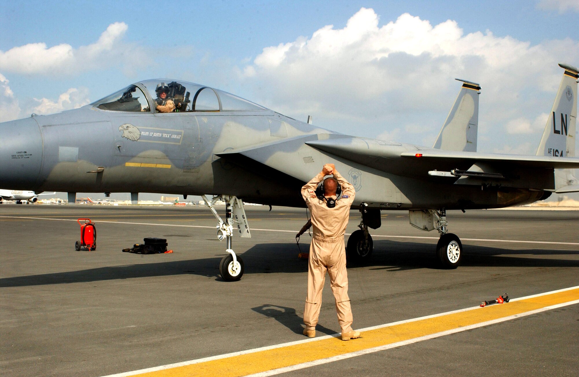 DUBAI, United Arab Emirates (AFPN) -- Tech. Sgt. Barry Snokhous directs Capt. Joey Hemphill to his parking location after his F-15 demonstration practice for the Dubai Air Show. The F-15 is part of the West Coast Demonstration Team, and both Airmen are supporting the air show from Eglin Air Force Base, Fla.  (U.S. Air Force photo by Tech. Sgt. Andrew F. Hammonds Jr.)