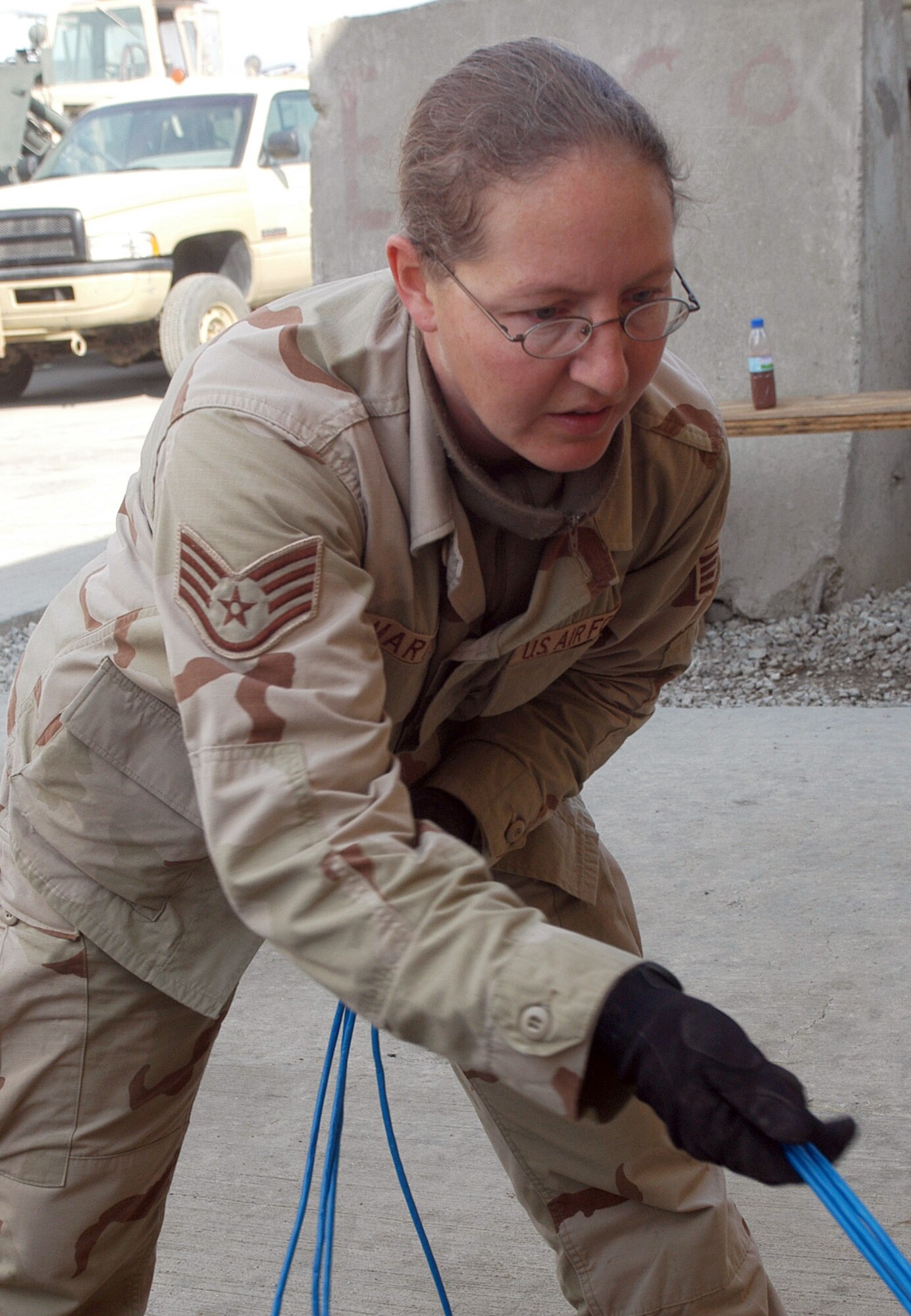 BAGRAM AIRFIELD, Afghanistan (AFPN) -- Staff Sgt. Carey Martin helps replace 75 yards of broken network cable. Since arriving here in September the team has re-run more than 20 network lines. Sergeant Martin, a native of Lafayette, Ind., is deployed from Davis-Monthan Air Force Base, Ariz. (U.S. Air Force photo by Staff Sgt. Marcus McDonald