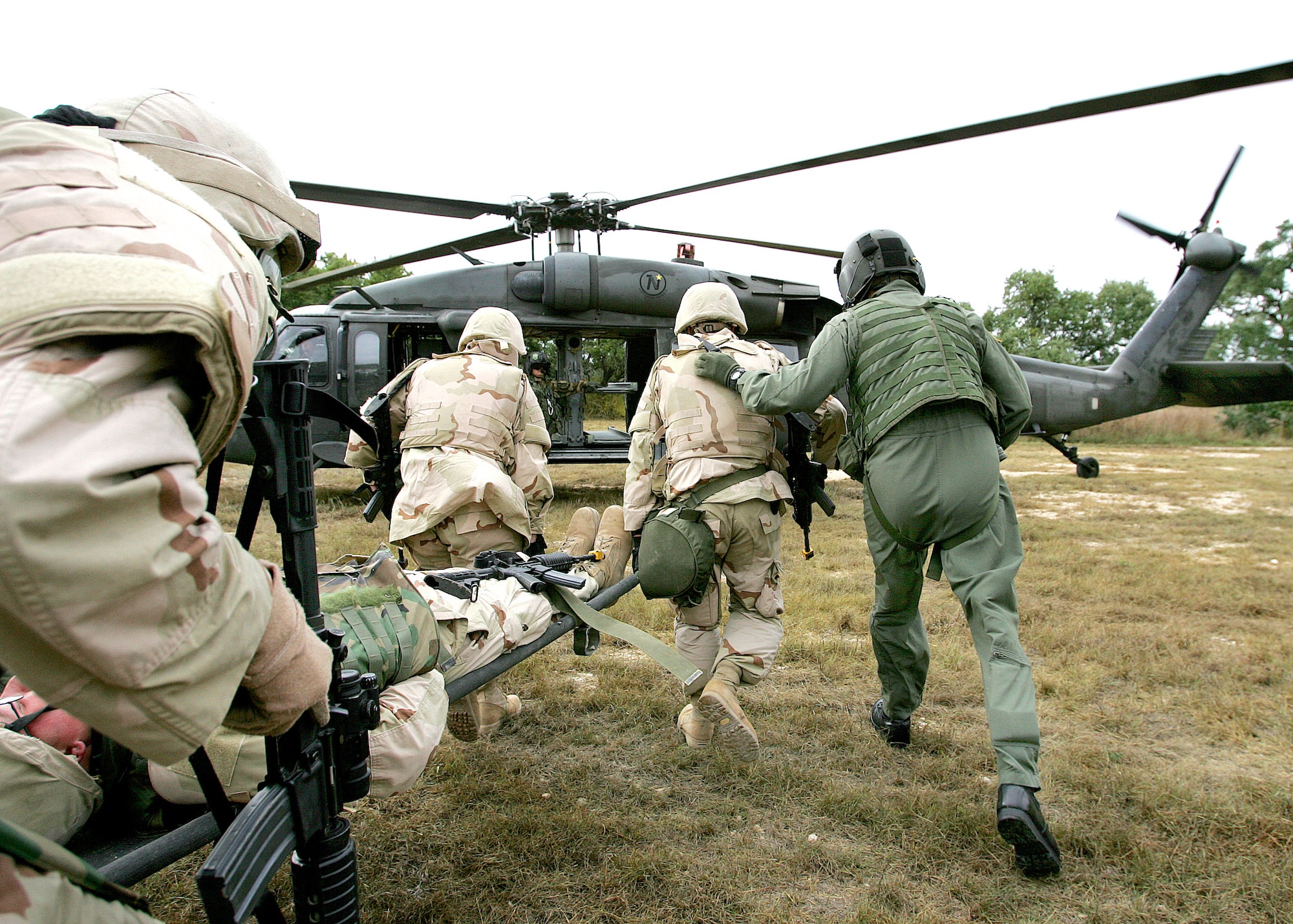 CAMP BULLIS, Texas (AFPN) -- Students of the basic combat convoy course load "casualties" on a helicopter following a simulated firefight with insurgents.  (U.S. Air Force photo by Robbin Cresswell) 