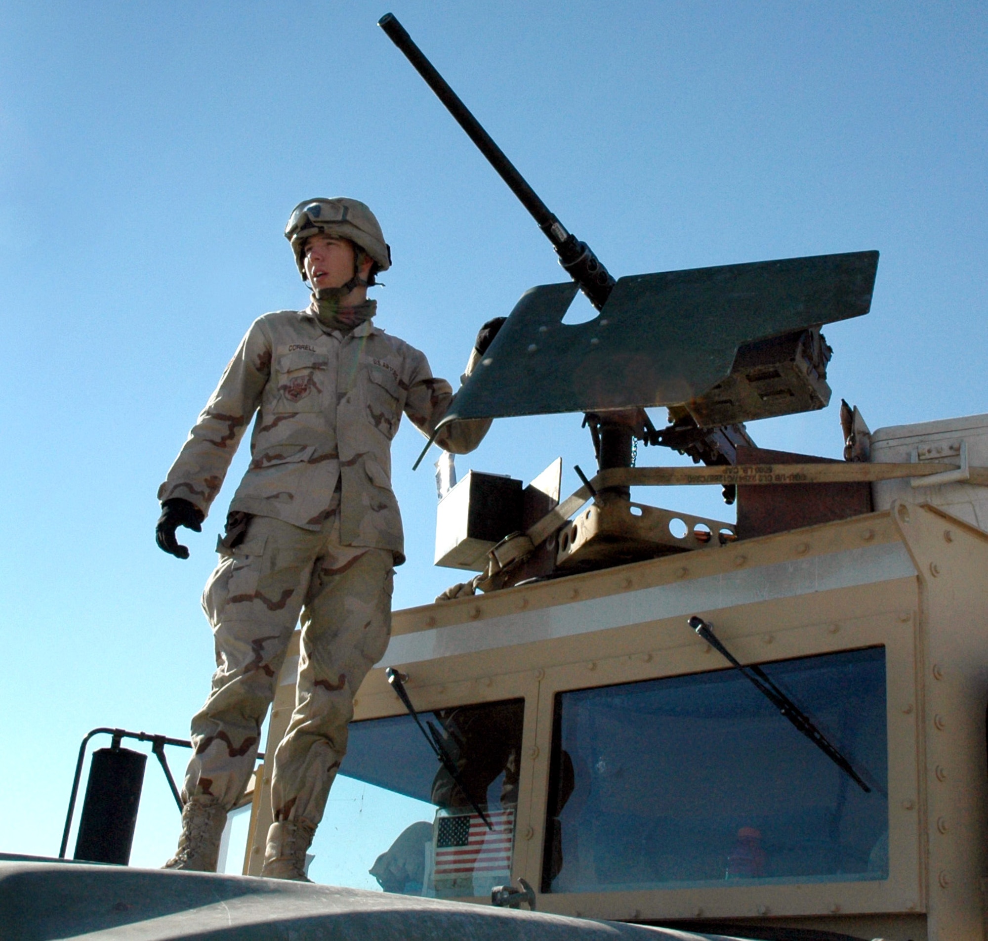 TIKRIT, Iraq -- Senior Airman James Correll stands atop a 5-ton truck as he prepares to set out on a convoy from forward operating base Speicher. Airmen with the 732nd Expeditionary Logistics Readiness Squadron here provide armed escort of combat logics patrols to ensure passengers and cargo safely reach their destinations throughout Iraq. (U.S. Air Force photo by Maj. Robert Couse-Baker)
