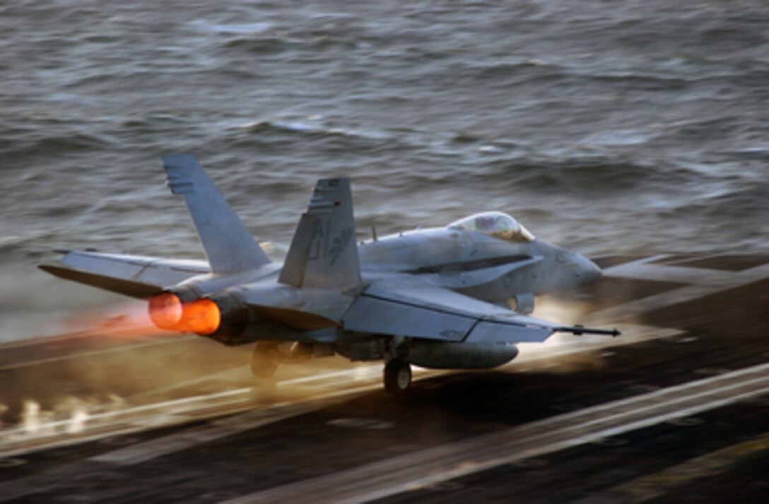 The afterburners of a Navy F/A-18 Hornet glow as the aircraft launches from one of the waist catapults of the aircraft carrier USS Theodore Roosevelt (CVN 71) on Nov. 25, 2005. Roosevelt and its embarked Carrier Air Wing 8 are conducting flight operations in the Persian Gulf. The Hornet is assigned to Strike Fighter Squadron 87 of Naval Air Station Oceana, Va. 