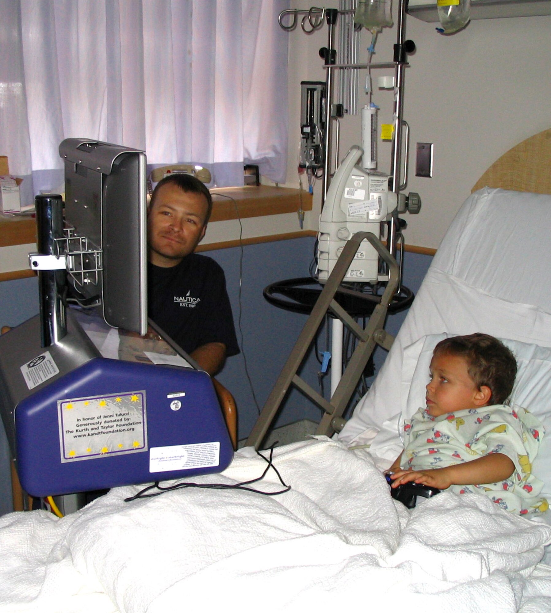 VANDERBERG AIR FORCE BASE, Calif. (AFPN) -- Tech. Sgt. Jeff Pitman and his son, Devin, 4, play video games during their recoveries from kidney transplant surgeries Sept. 14. Sergeant Pitman is in the 533rd Training Squadron.  (Courtesy photo)