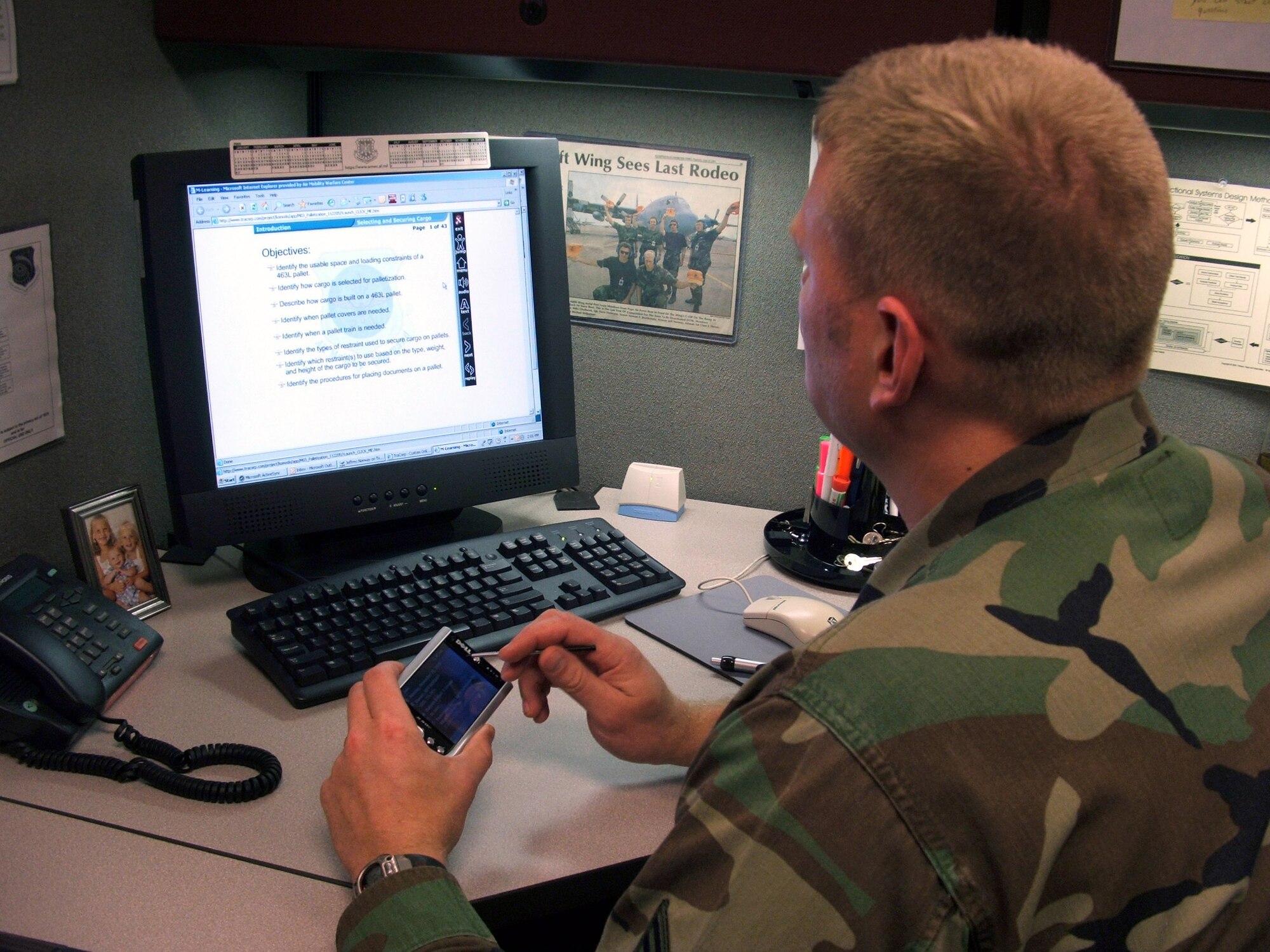 FORT DIX, N.J. (AFPN) -- Tech. Sgt. Jeff Norway programs a personal digital assistant device for use in the Air Mobility Warfare Center mobile learning initiative for the Air Force air transportation career field. (U.S. Air Force photo by Tech. Sgt. Scott T. Sturkol)