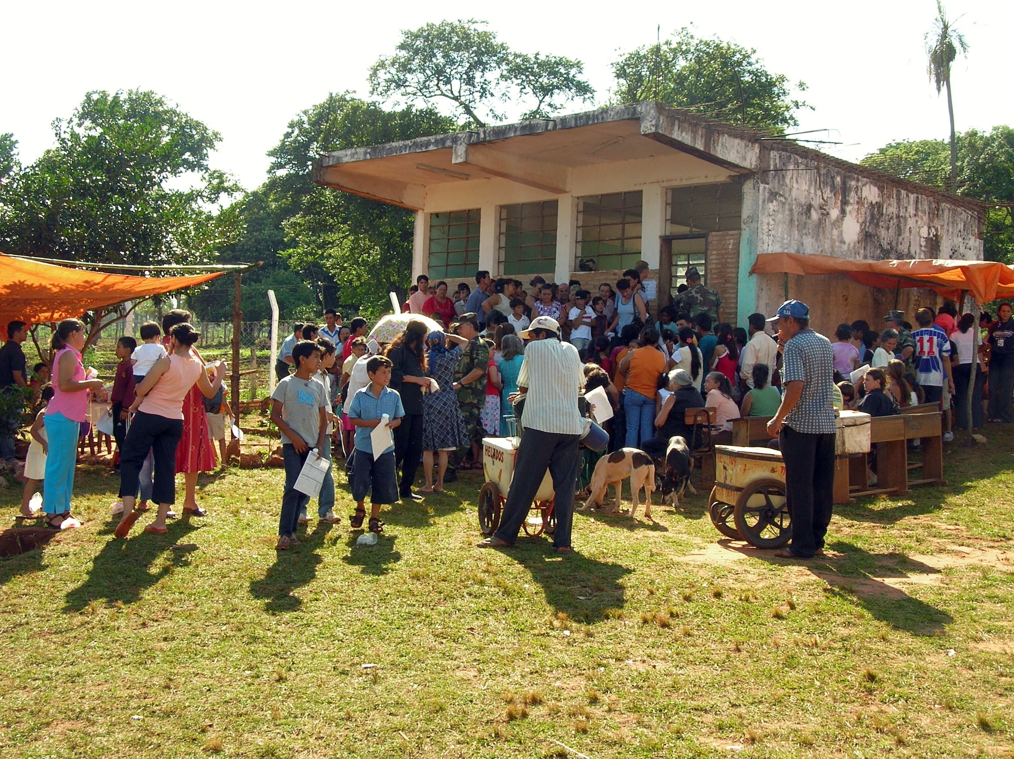 PARAGUAY (AFPN) -- Hundreds of people in a Paraguayan village wait in lines for a chance to be seen by a doctor. The real-world humanitarian aid mission helped several thousand people. Air Force doctors, dentists and optometrists worked with Paraguayan doctors for this mission. Ten members of the 9th Medical Group at Beale Air Force Base, Calif., recently returned from Paraguay after participating in a 15-day medical readiness training exercise.  (U.S. Air Force photo by Lt. Col. Marc Robins)