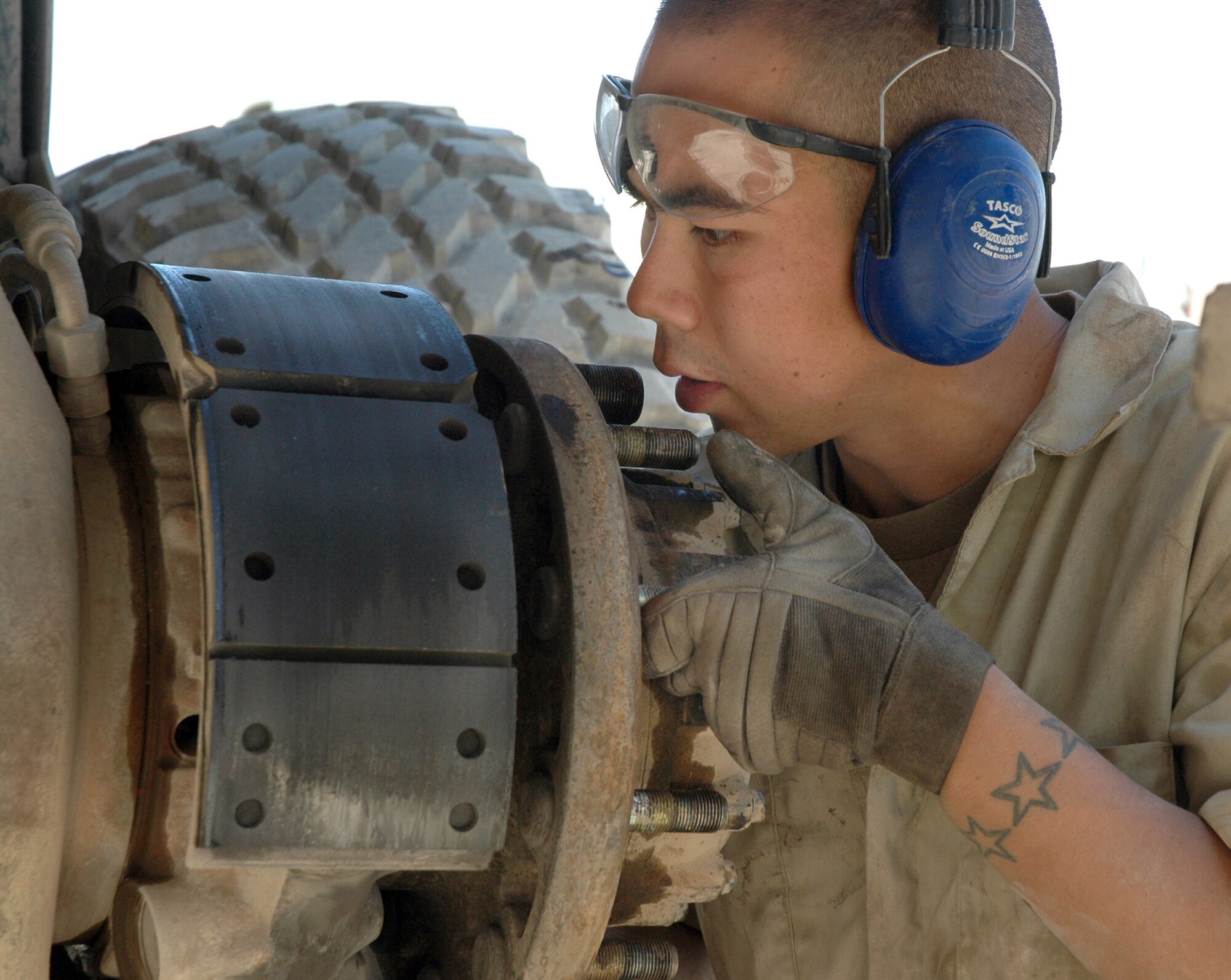 TIKRIT, Iraq (AFPN) -- Staff Sgt. Jason Gregg inspects an antilock-brake-system sensor on an M-1083 medium tactical vehicle. Mechanics assigned to the 732nd Expeditionary Logistics Readiness Squadron at base Speicher maintain armored gun trucks used by the Air Force convoy security detachment. Sergeant Gregg deployed from Misawa Air Base, Japan. (U.S. Air Force photo by Maj. Robert Couse-Baker) 