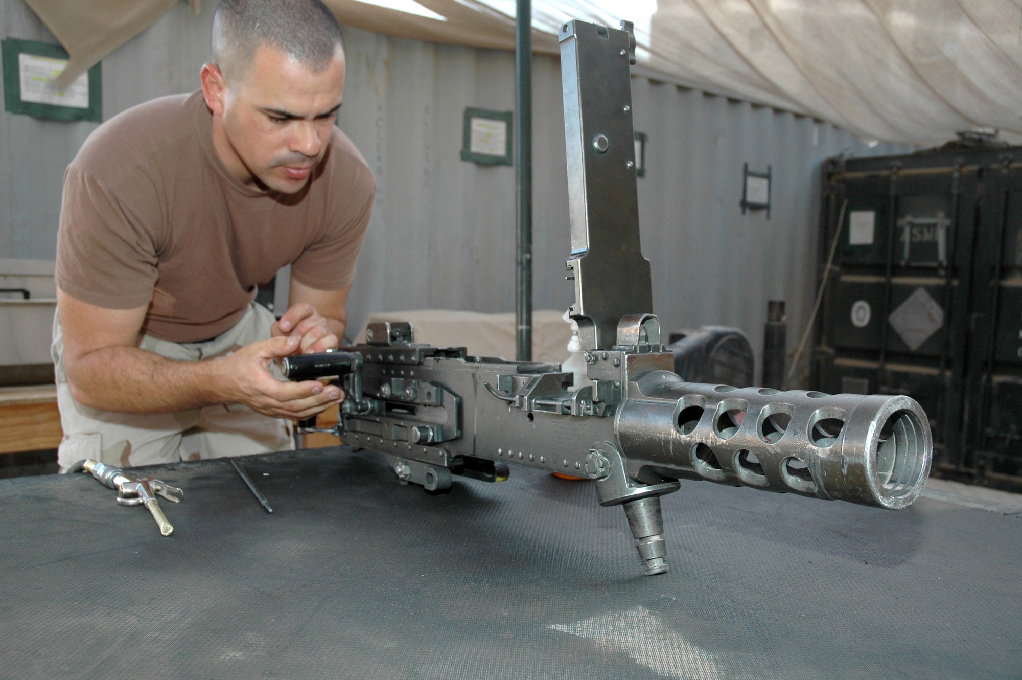 TIKRIT, Iraq (AFPN) -- Staff Sgt. Ricardo Remesal-Lopez cleans and checks the operation of a 50-cal machine gun before a night convoy at base Speicher. Airmen with the 732nd Expeditionary Logistics Readiness Squadron provide armed escort of combat patrols to ensure passengers and cargo reach their destinations throughout Iraq. Sergeant Remesal-Lopez deployed from Lackland Air Force Base, Texas. (U.S. Air Force photo by Maj. Robert Couse-Baker)